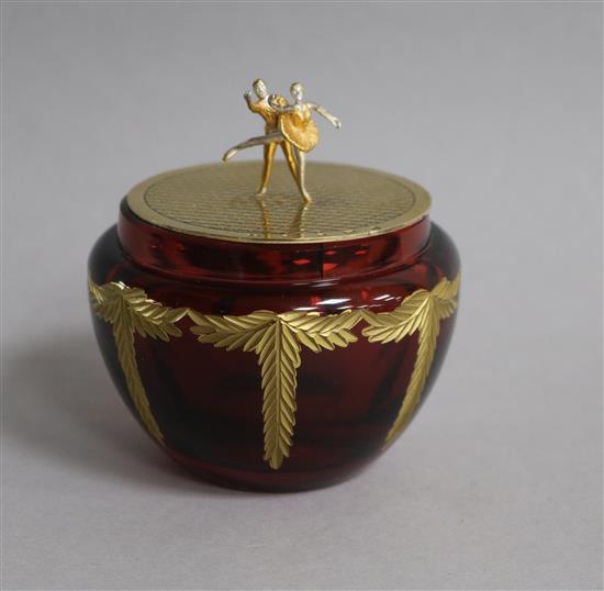 A modern Theo faberge silver gilt lidded ruby glass jar, with ballerinas finial, Birmingham, 2001, height 86mm.